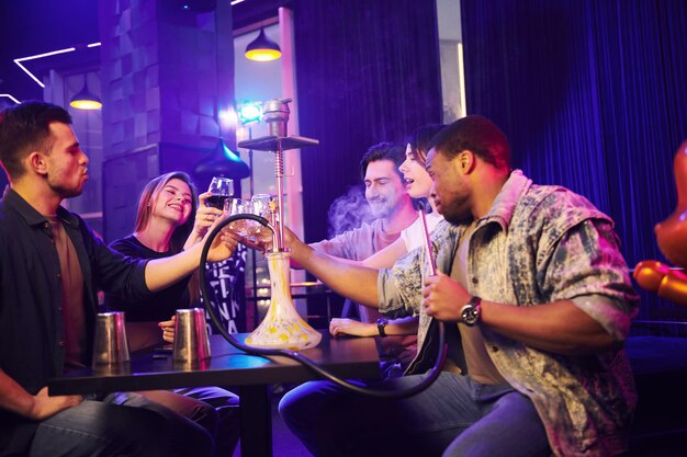 smoking-hookah-group-friends-having-fun-night-club-together_146671-69287