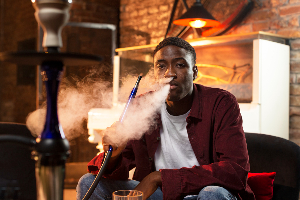 young-man-vaping-from-hookah-bar